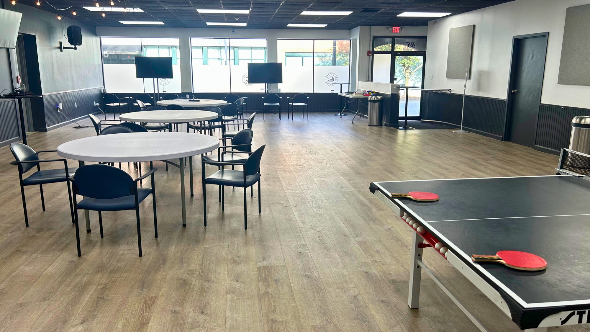Open El Centro venue with tables, chairs, and a ping pong table